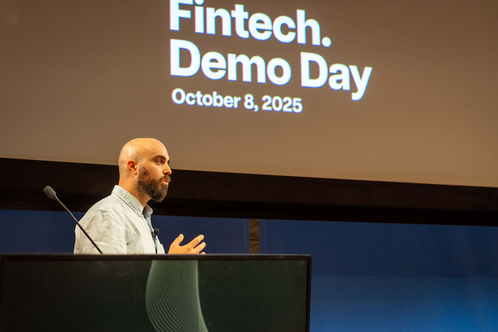 Speaker at podium with Fintech Demo Day October 8, 2025 title slide