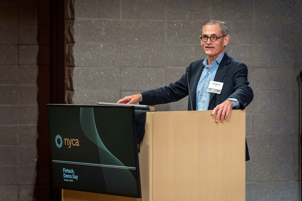 Hans Morris welcoming attendees at the NYCA Fintech Demo Day podium