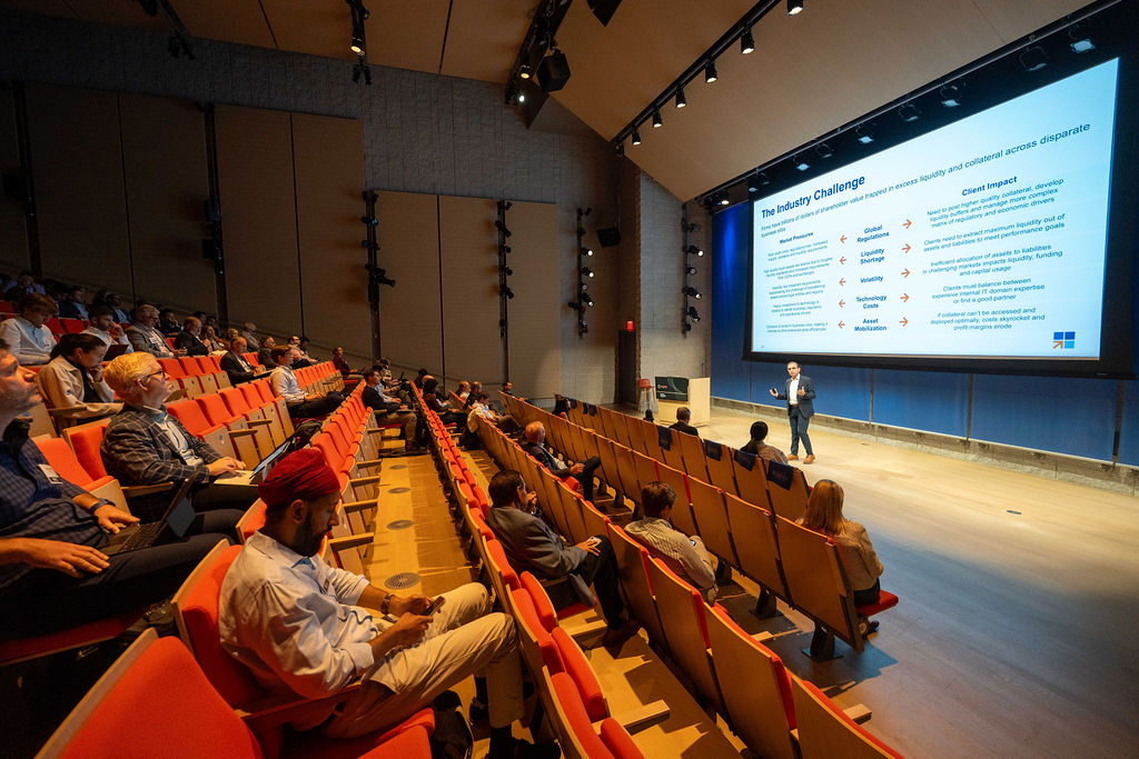 A founder presenting to a full auditorium at Fintech Demo Day 2025